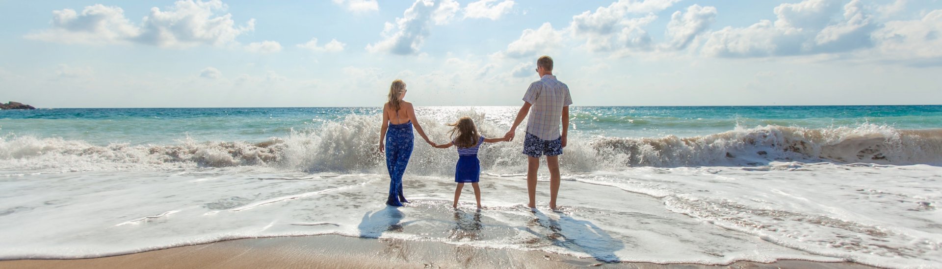 family stood in the surf