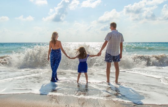 family stood in the surf