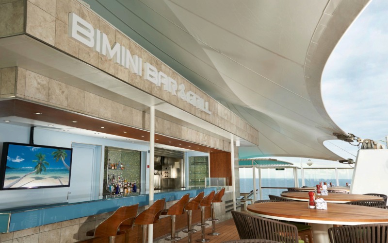 NCL pool deck casual dining — outdoor grills and waterpark views